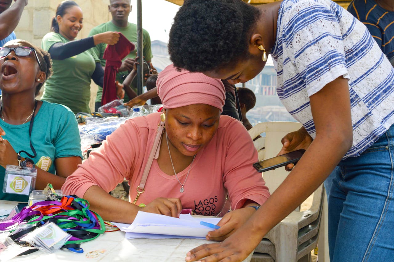 why-choose-us Group of volunteers working on registration at a community event outdoors.